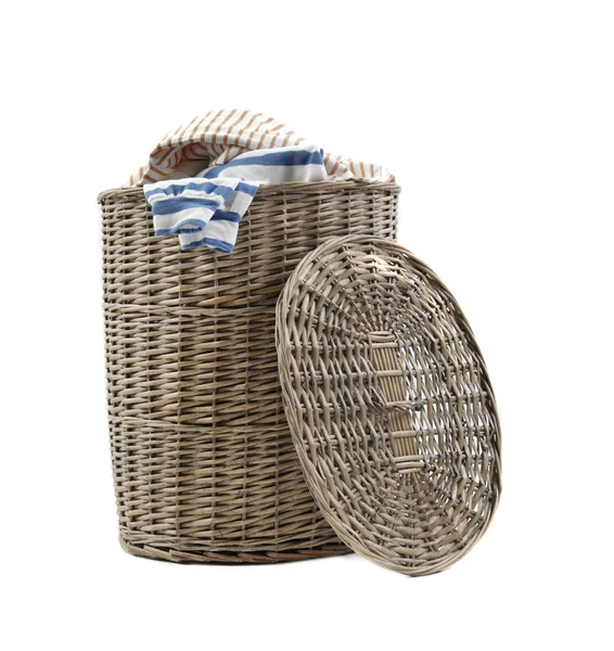 Wicker laundry basket with dirty clothes on white background — Stock Photo, Image