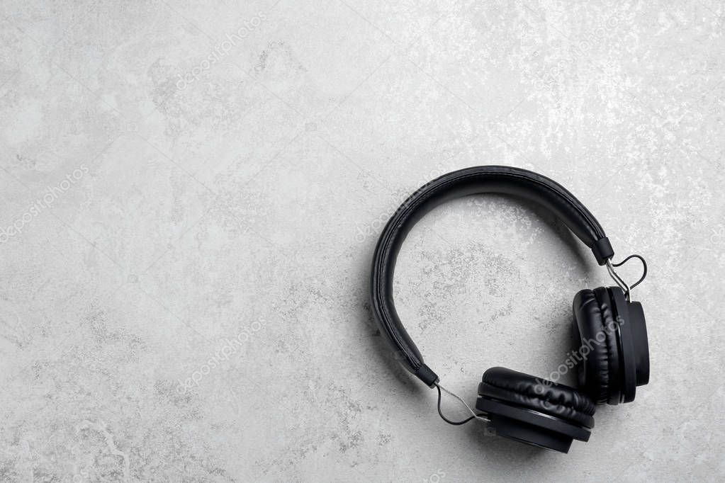 Stylish headphones on grey background, top view. Space for text