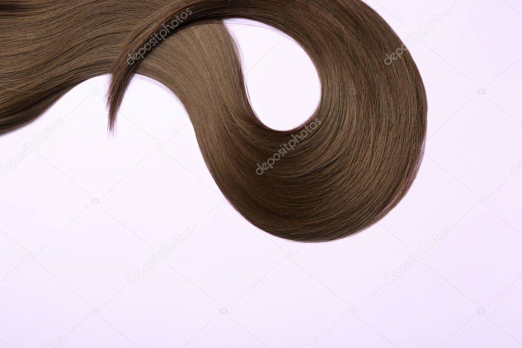 Beautiful brown straight hair on light background, space for text