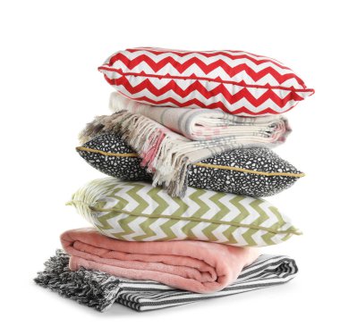 Beyaz arka planda şık yumuşak yastıklar ve katlanmış plaids