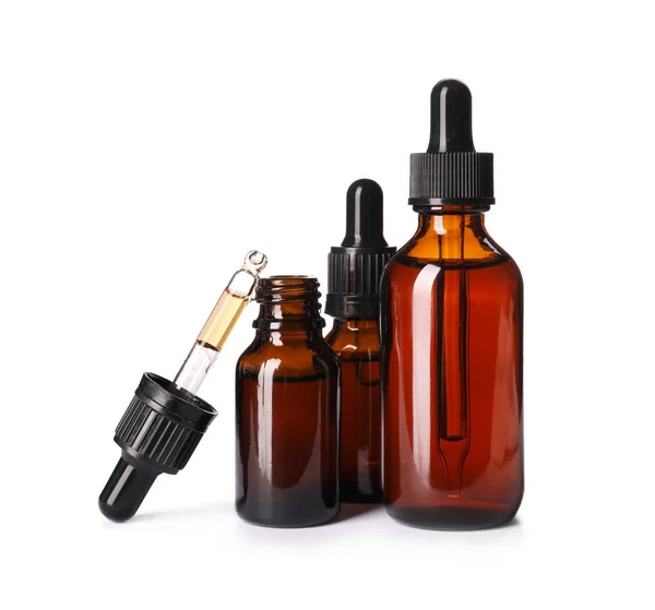Cosmetic bottles of essential oils on white background — Stock Photo, Image
