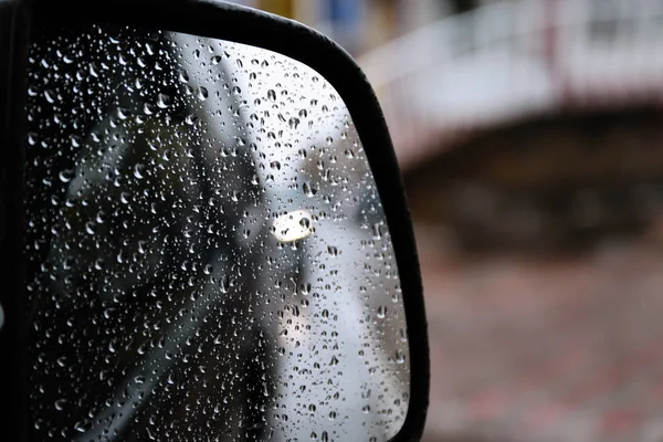 Closeup of car side rear view mirror with rain drops — Stock Photo, Image