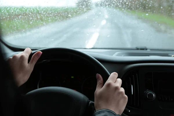 Woman driving car on rainy day, closeup of hands — 스톡 사진