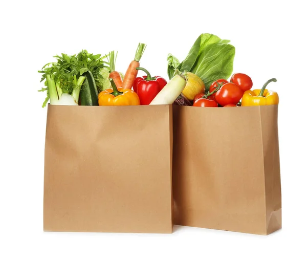 Paper bags with fresh vegetables on white background Stock Photo