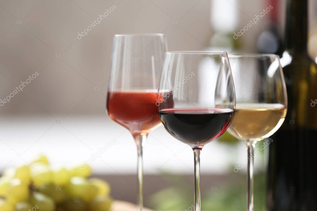 Different glasses with wine served on table