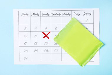 Calendar and menstrual pads on color background, top view. Gynecological care clipart