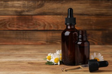 Masada papatya uçucu yağ şişeleri ile Kompozisyon. Metin için alan