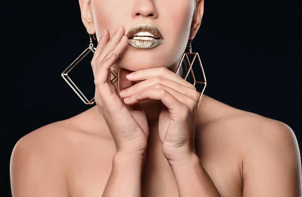 Beautiful lady with gold lipstick on black background, closeup — Stock Photo, Image