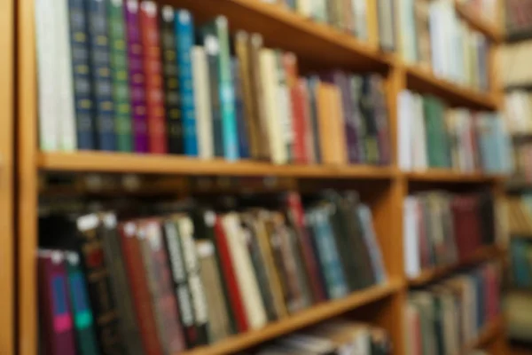 Vista borrosa de los armarios con libros en la biblioteca — Foto de Stock