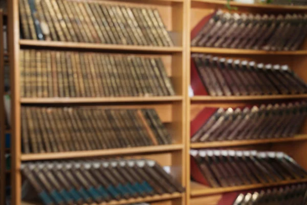 Blurred view of cabinets with books in library — Stock Photo, Image