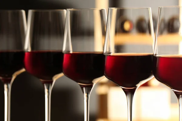 Glasses of red wine in cellar, closeup. Expensive drink — Stock Photo, Image