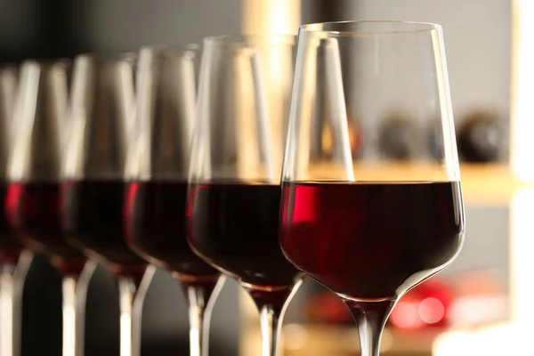 Glasses of red wine in cellar, closeup. Expensive drink — Stock Photo, Image