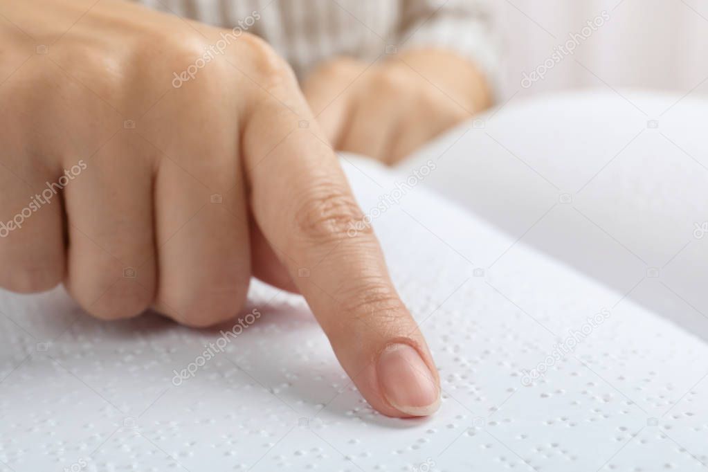 Blind person reading book written in Braille, closeup