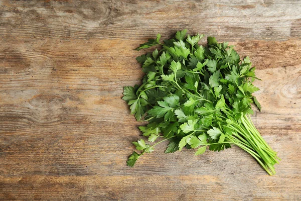 Bunch of fresh green parsley on wooden background, view from above. Space for text — Stock Photo, Image