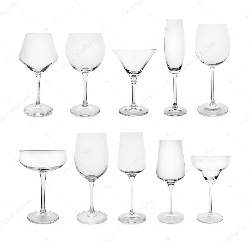 Set of different empty glasses on white background