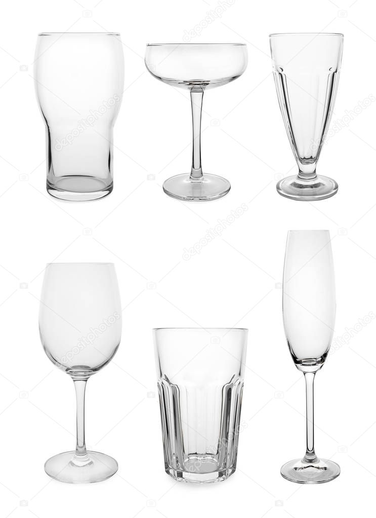 Set of different empty glasses on white background