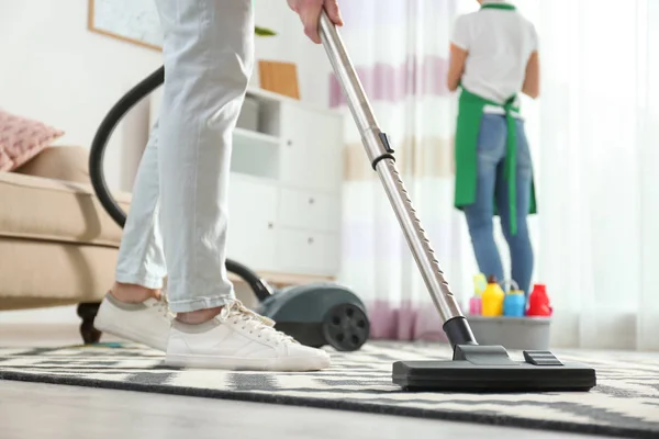 Cleaning service professional vacuuming carpet indoors, closeup — Stock Photo, Image