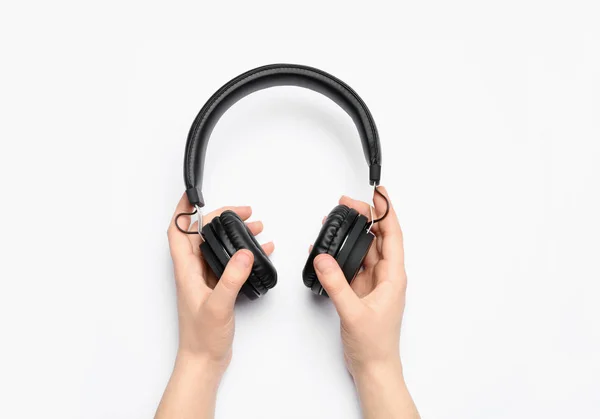 Woman holding stylish headphones on white background, closeup — ストック写真