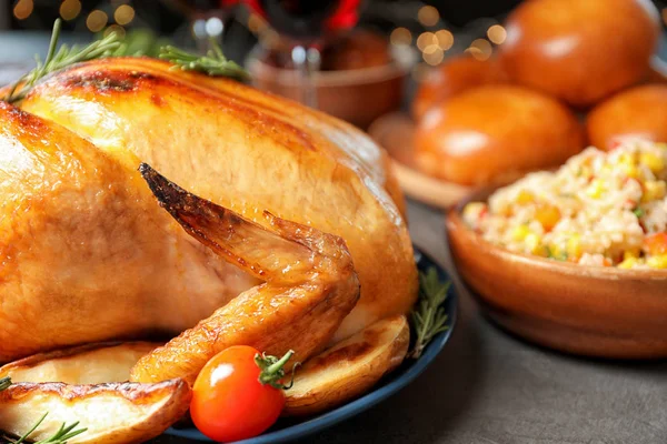 Delicious roasted turkey for traditional festive dinner on table, closeup