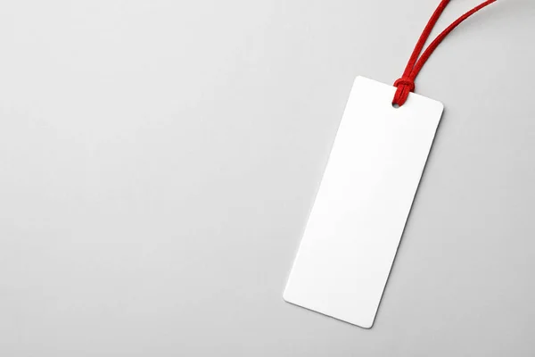 Cardboard tag with space for text on light background, top view