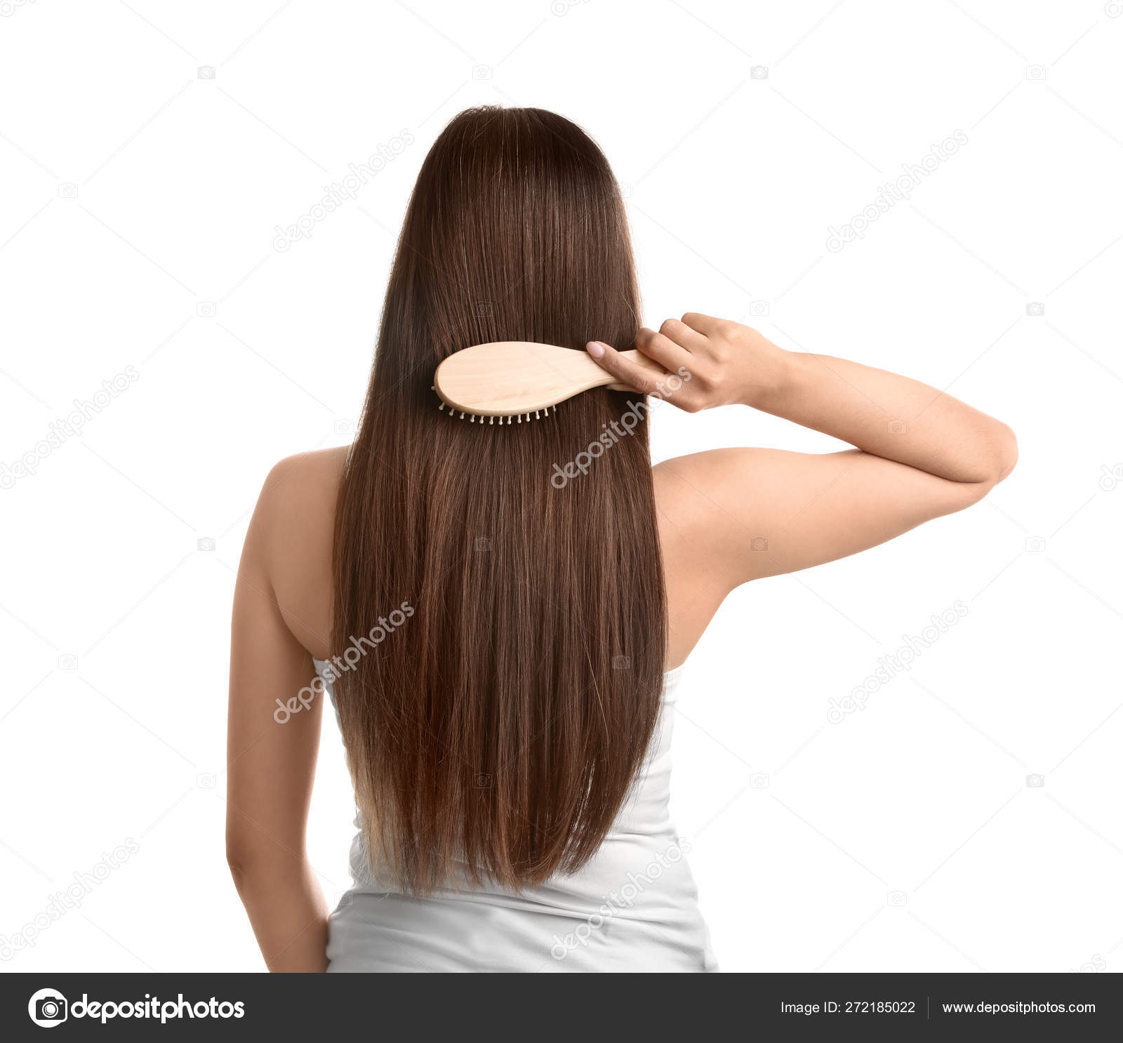 Back view of young woman with hair brush on white background Stock