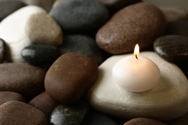 Güzel Spa taşlar üzerinde küçük yanan mum, metin için alan