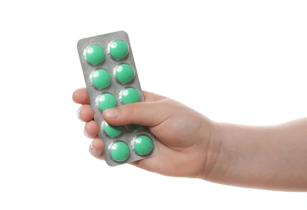 Little child with pills on white background, closeup. Danger of medicament intoxication — Stock Photo, Image