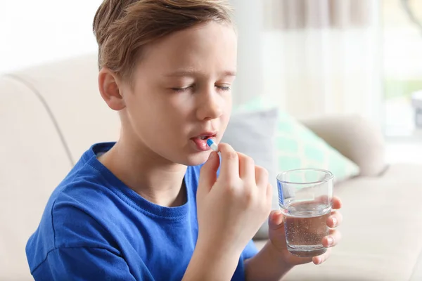 Little child taking pill at home. Danger of medicament intoxication — Stock Photo, Image