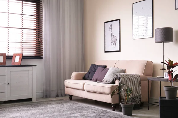 Интерьер гостиной с диваном и стильными элементами декора — стоковое фото