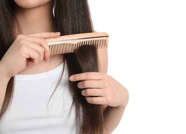 Young woman with wooden hair comb on white background, closeup — Stock Photo, Image