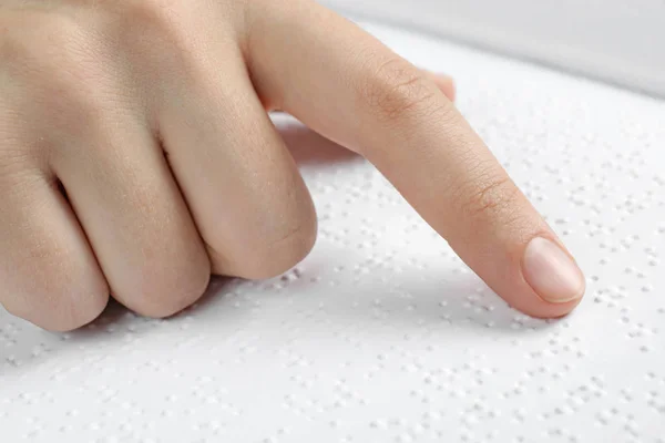 Blind person reading book written in Braille, closeup