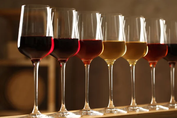 Glasses of different wines in cellar. Expensive collection — Stock Photo, Image