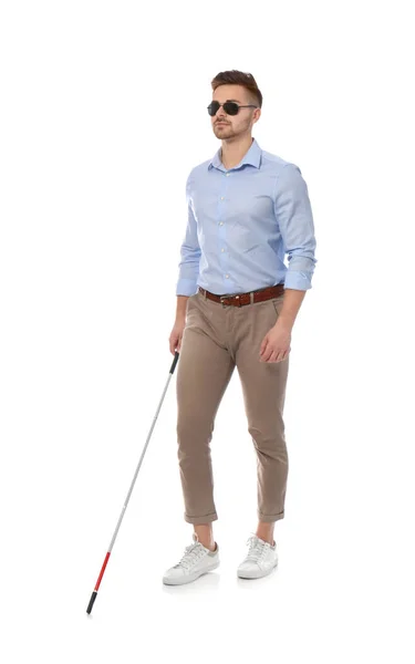 Young blind person with long cane walking on white background — Stock Photo, Image