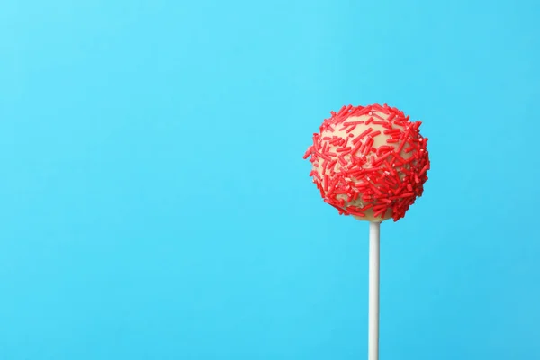 Yummy bright cake pop on color background. Space for text