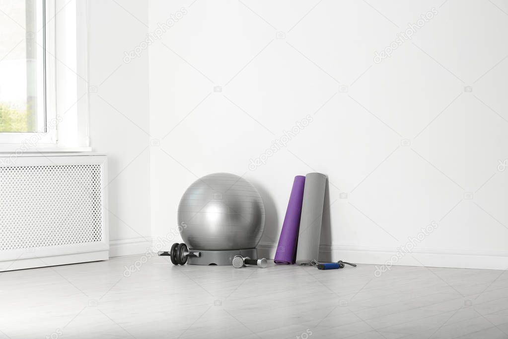 Set of fitness inventory on floor in rehabilitation center