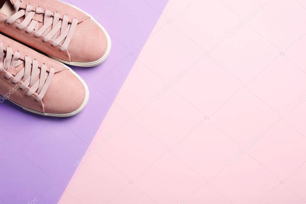 Bright stylish shoes on color background, top view. Space for text