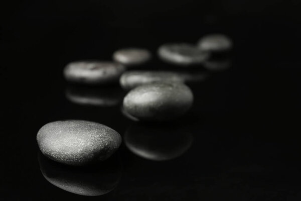 Spa stones on black background. Space for text