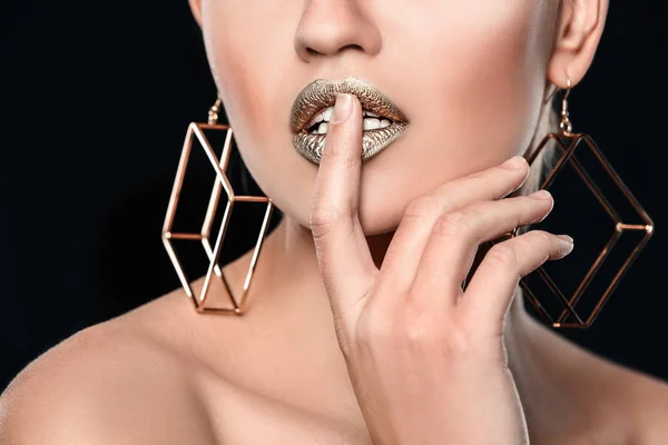Siyah arka plan üzerinde altın ruj ile güzel bayan, closeup