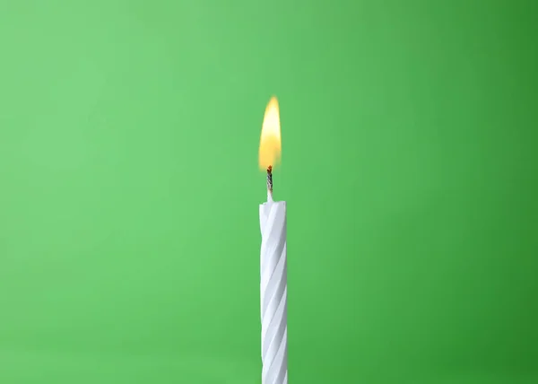 Burning birthday cake candle on color background. Space for text — Stock Photo, Image