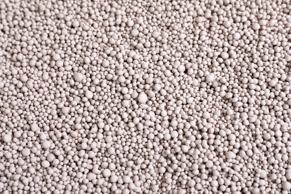 Textured chemical fertilizer for gardening as background, top view