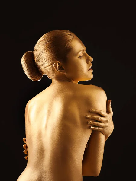 Portrait of beautiful lady with gold paint on skin against black background — Stock Photo, Image