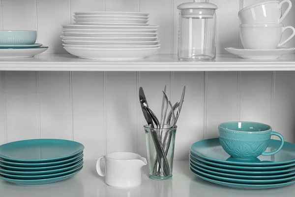 White shelving unit with set of dishware — Stock Photo, Image