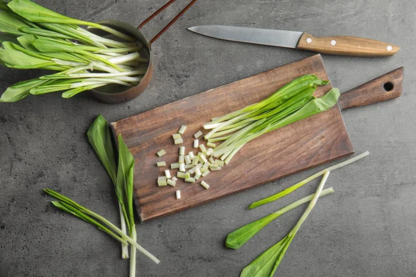 Flat lay composition with wild garlic or ramson on grey table