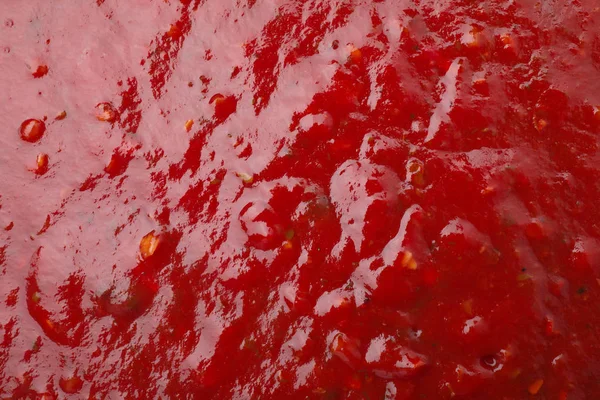 Molho picante vermelho saboroso como fundo, close-up — Fotografia de Stock