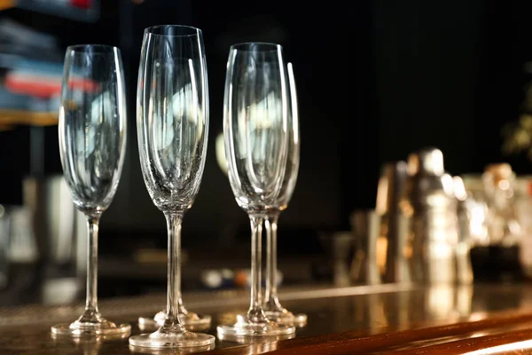 Empty clean champagne glasses on counter in bar. Space for text Stock Picture