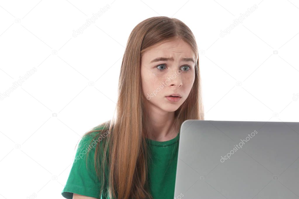 Shocked teenage girl with laptop on white background. Danger of internet
