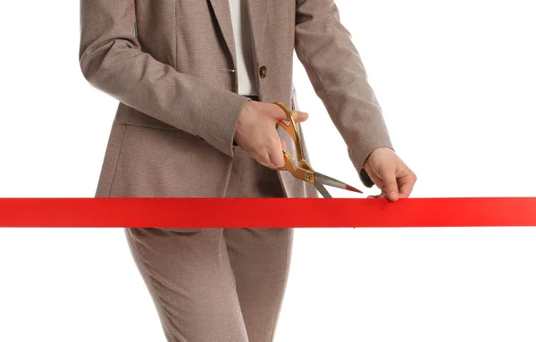 Mujer en traje de oficina cortando cinta roja aislada en blanco, primer plano —  Fotos de Stock