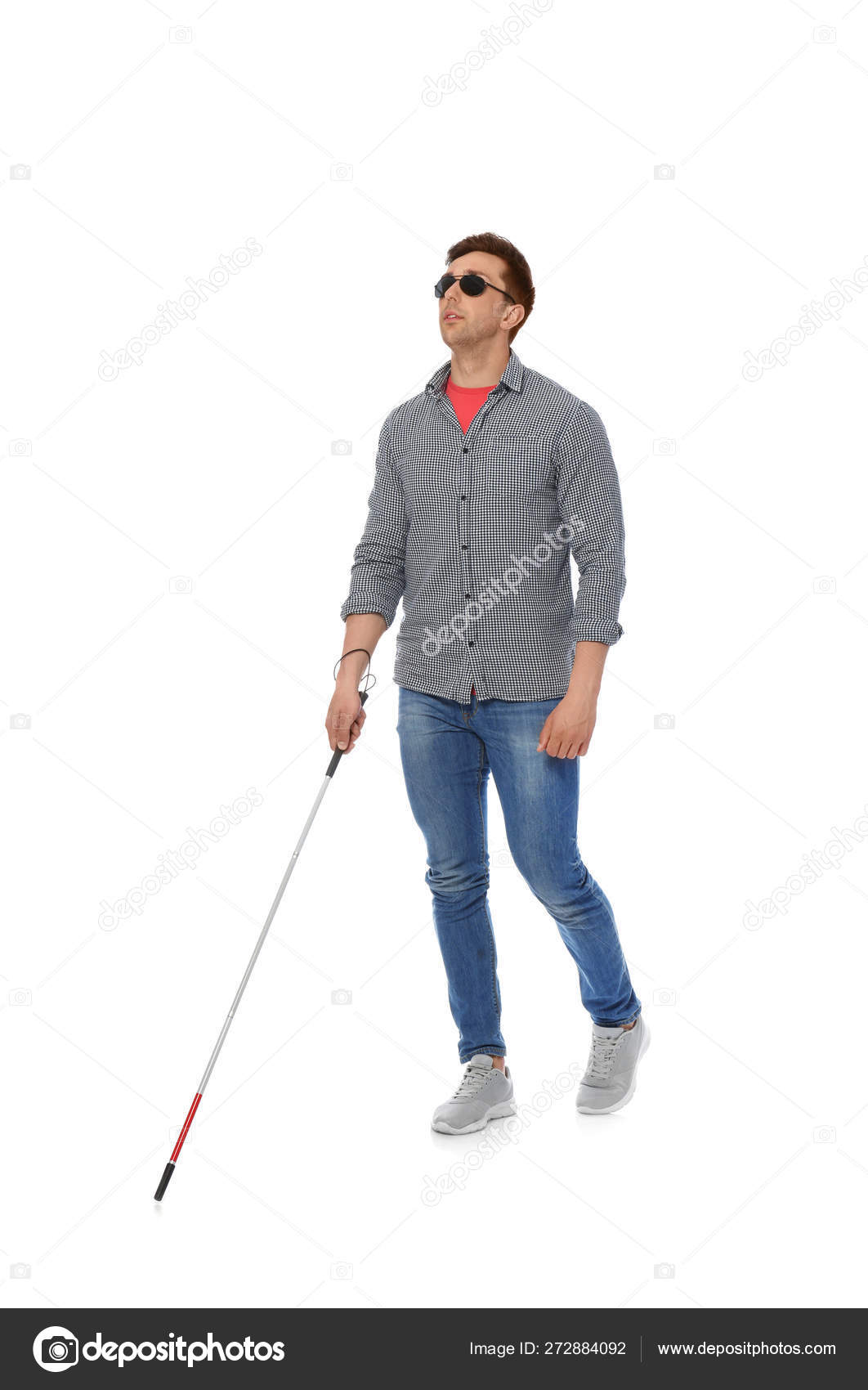 Young blind person with long cane walking on white background 272884092