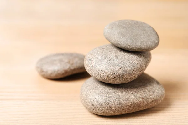 Stack of spa stones on wooden table. Space for text — Stock Photo, Image