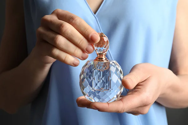 Woman holding glass perfume bottle, closeup view — Stock Photo, Image